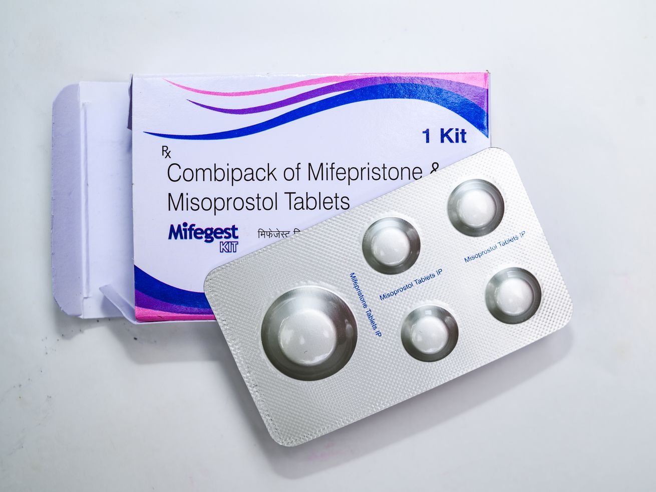 A box of mifepristone pills, with a silver blister pack taken out of the box, at a pharmacy.