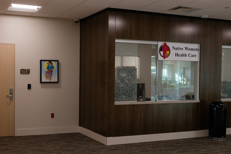 A reception desk with a sign that reads “Native Women’s Health Care.”