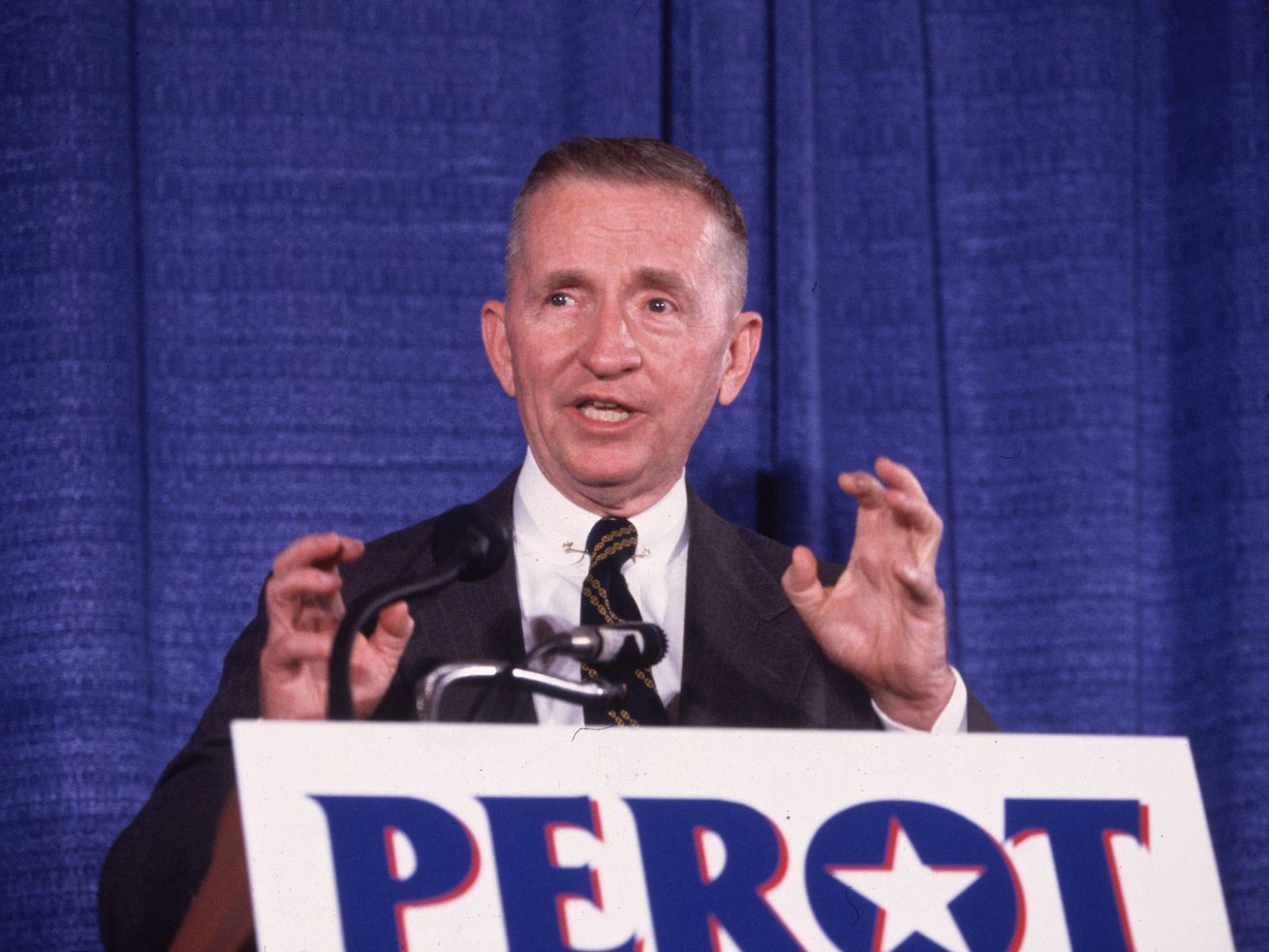 American businessman and politician Ross Perot, undeclared candidate for president, speaking and gesticulating at a podium during a press conference, Annapolis, Maryland.