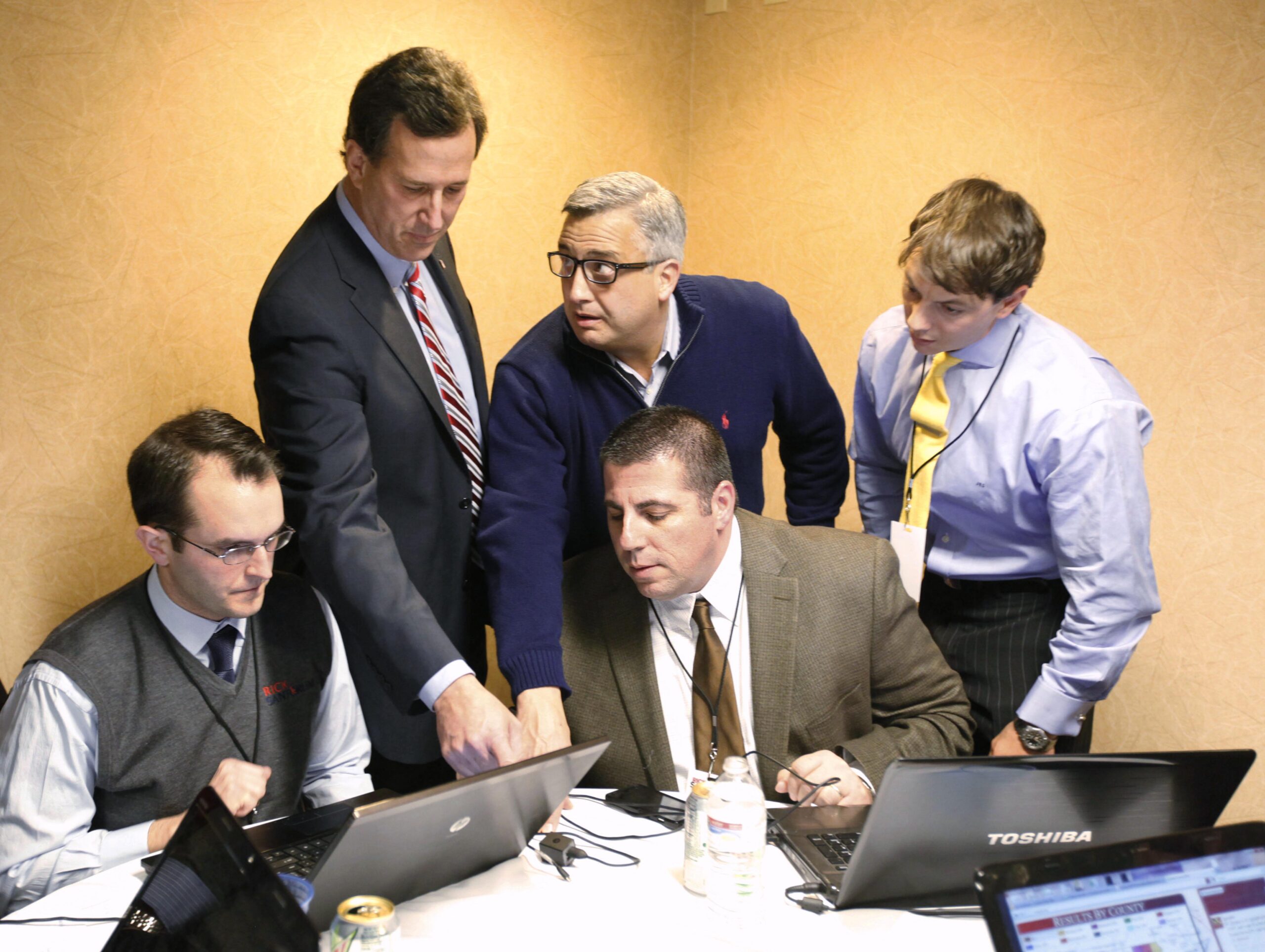 Rick Santorum (top left) looks over Iowa Republican presidential caucus returns with his campaign staff in 2012. Santorum entered the final week so far behind Romney that he was in sixth place in the RealClearPolitics polling average.