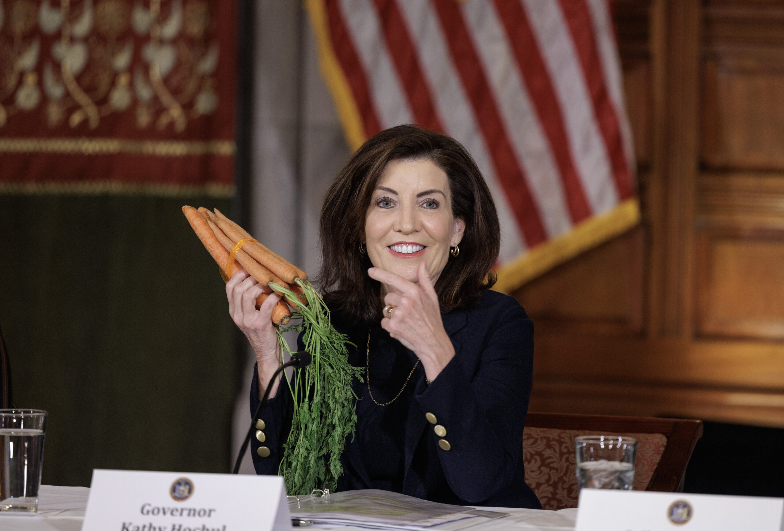 Gov. Kathy Hochul displayed carrots as a way to show she's offering carrots and sticks in her bid for more housing development in New York during a news conference Feb. 7, 2024, at the state Capitol in Albany, N.Y.