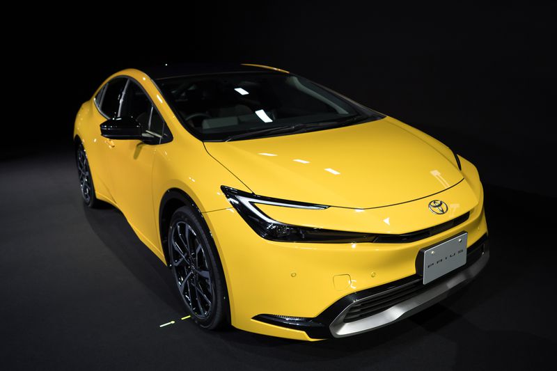 A yellow and black Prius 2.0L plug-in hybrid electric vehicle prototype.