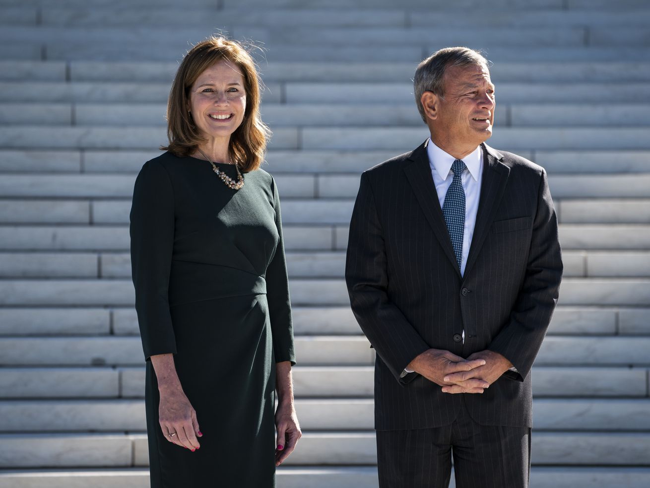 Barrett and Roberts standing in front of the steps of the Supreme Court.